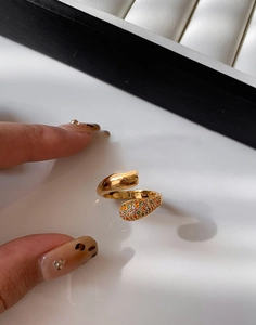 Macro shot of 18K gold plated cross ring with colorful cubic zirconia and water drop detail
