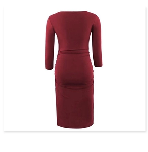 Detail view of burgundy long sleeve midi dress featuring side ruching and bodycon fit