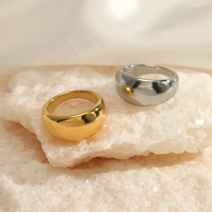 Polished gold and silver wide curved stainless steel rings on decorative crystal stones
