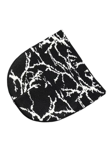 Detail showing the white lightning jacquard pattern on a black knit beanie