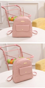 Detail view of pink mini PU leather backpack with embossed floral and heart patterns