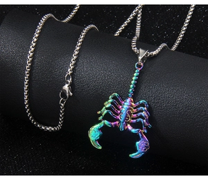 Macro shot of colorful scorpion pendant on black stand showing metallic texture