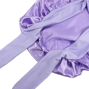 Detailed view of light purple satin sleep bonnet showing glossy fabric and elastic straps