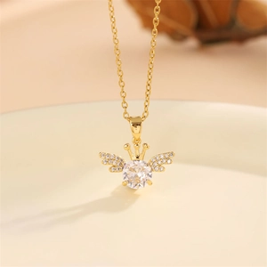 Elegant gold crown and angel wings necklace with a sparkling round gemstone pendant
