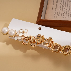 Elegant 10-piece gold flower earring set with pearls and enamel on a display card