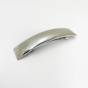 Detailed view of silver alloy spring hair clip with horizontal textures on white background