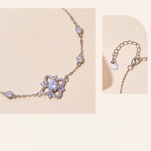 Detail of S925 silver flower bracelet with lobster clasp and heart extension chain