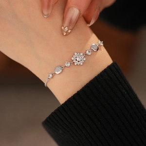 Macro shot of silver flower bracelet with sparkling cubic zirconia on a wrist