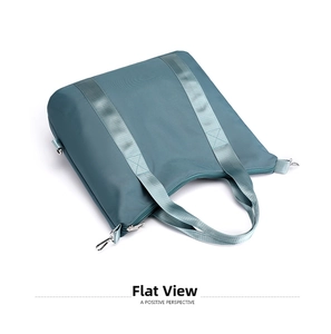 Detailed view of reinforced webbing handles and silver metal zipper on nylon tote bag