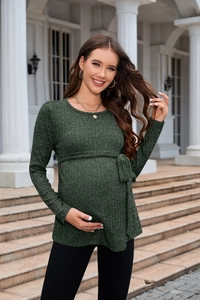 Detail of dark green knit maternity sweater featuring ribbed texture and waist tie belt
