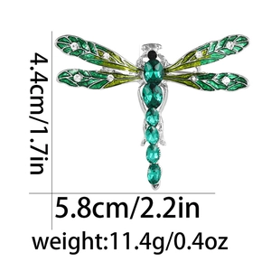 Detail showing dragonfly brooch dimensions 5.8cm width with green enamel and crystals