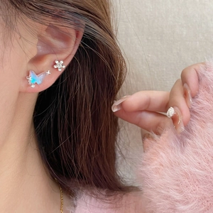Iridescent butterfly and flower stud earrings set in a sweet aesthetic style