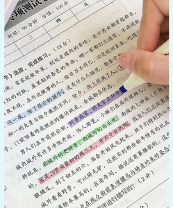 Close-up of purple highlighter tip marking key text on paper with white barrel design