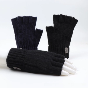 Close-up of knit fingerless gloves with ribbed cuffs and reindeer decorative labels