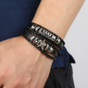 Black leather multilayer bracelet set with silver hollow beads and star pendant on wrist