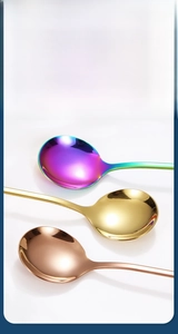 Detail of polished round spoons in iridescent, gold, and rose gold with smooth edges
