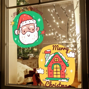Close-up of Santa Claus and snowy cottage static window decals with Merry Christmas text