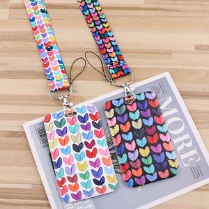 Polyester heart pattern ID card holders with lanyards on wooden magazine background