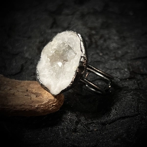 Macro detail of raw white crystal geode slice on handcrafted rustic silver adjustable ring