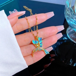 Gold hummingbird necklace with gradient enamel and zircon inlay on a delicate chain
