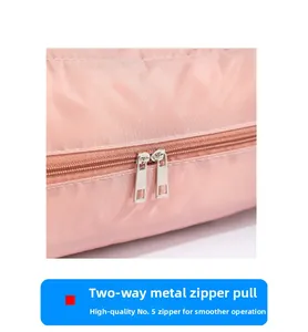 Close-up of pink travel bag showing premium two-way metal zippers for smooth operation