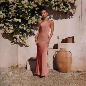 Detail of rose pink satin halter maxi dress featuring backless design and glossy fabric