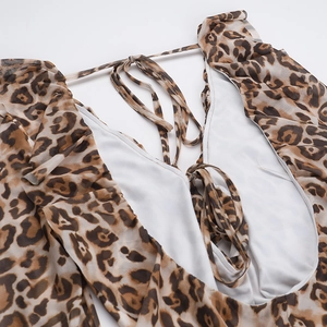 Detailed view of leopard print mini dress featuring open back design and thin lace-up straps