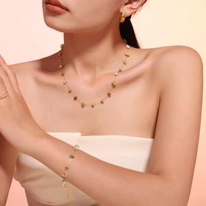 Elegant gold necklace, bracelet and earring jewelry set with green natural crushed stones