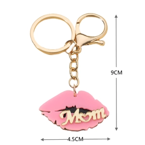 Detail view of pink lips keychain with gold MOM letter charm and dimension measurements