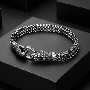 Close-up of vintage stainless steel snake scale bracelet with dual snake head clasp