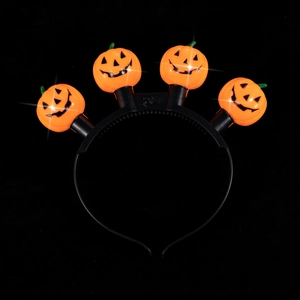 Halloween pumpkin headband with orange LED glowing lights on a black flexible hairband