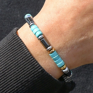 Detailed close-up of men's beaded bracelet featuring turquoise and hematite stones