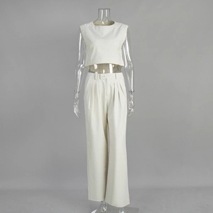 Detail von Leinen-Oberteil und weithosiger Hose mit hohem Bund und Knopfdesign