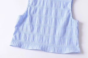 Detailed macro view of the blue and white plaid fabric texture with crinkle pleated finish