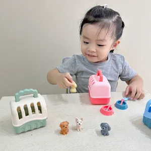 Close-up of a child playing with colorful pet carrier toys and mini plush dog figurines