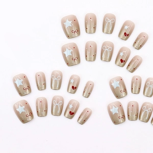 Faux ongles courts mignons dégradés avec cœurs rouges, nœuds et finition pailletée