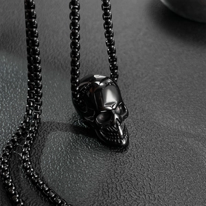Close-up of gothic black skull pendant on a matching round box chain for men