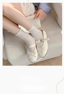 Detail of white ruffle socks paired with Mary Jane shoes showing mesh pattern
