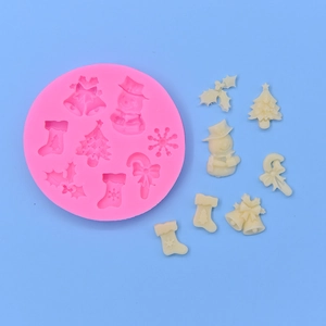 Pink silicone mold featuring snowman and bell shapes for Christmas cake decorating