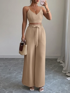 Dettaglio del set cammello con top scollo a V e pantaloni larghi con cintura in vita