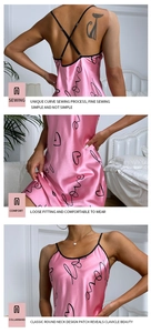 Detail view of pink satin nightdress with cross back straps and Love print pattern