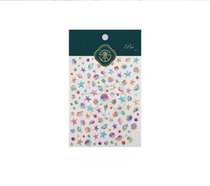 Macro detail of 5D holographic sea shell and starfish nail art stickers with 3D pearl texture