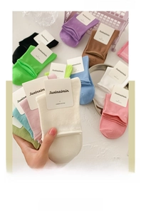 Close-up of candy-colored rolled edge crew socks made from premium combed cotton