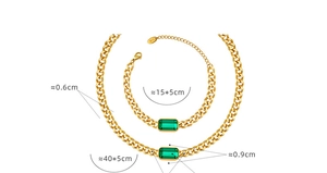 Macro view of gold Cuban chain set with green stones and precise size dimensions