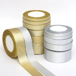Stack of gold and silver metallic glitter ribbons for DIY Christmas gift decorations