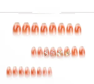 Close-up of French brown gradient press-on nails with 3D butterfly and floral accents