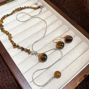 Tiger eye stone jewelry set featuring beaded necklace and earrings on a wooden display box