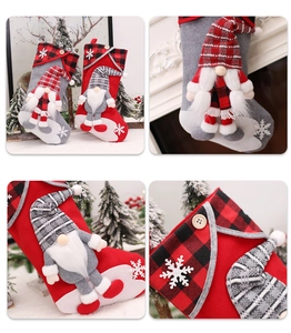 Detail of red and grey Christmas stockings with 3D faceless Santa dolls and plaid patterns