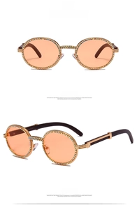 Macro shot of luxury champagne lens sunglasses featuring colorful rhinestone encrusted frames