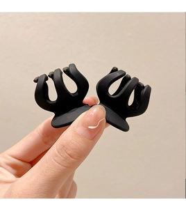 Close-up of a black matte small hair claw clip for high ponytail styling and secure grip
